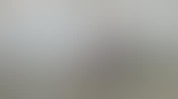 Girl on a sand dune looking out to sea (preview)