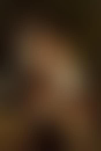 Girl in national dress with younger girl on lap (preview)