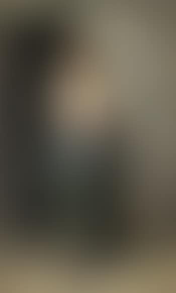 Girl leaning against the wall of a house (preview)