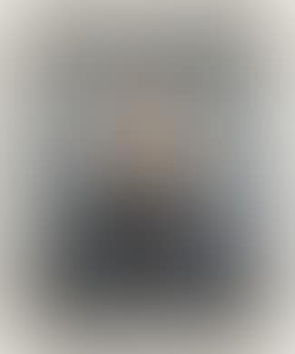 A portrait of of a gentleman with a moustache against a grey background (preview)