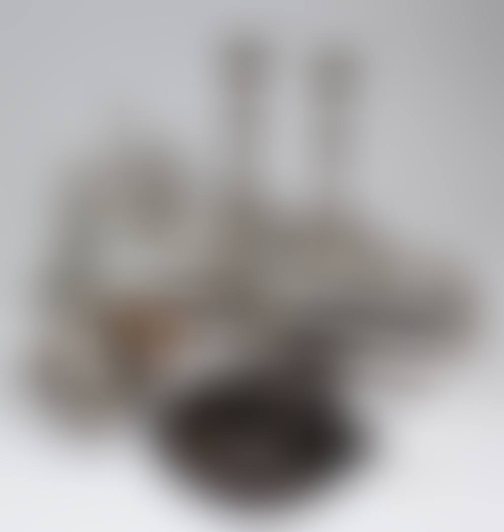 A pair of plated pillar candlesticks with leaf mounts (preview)