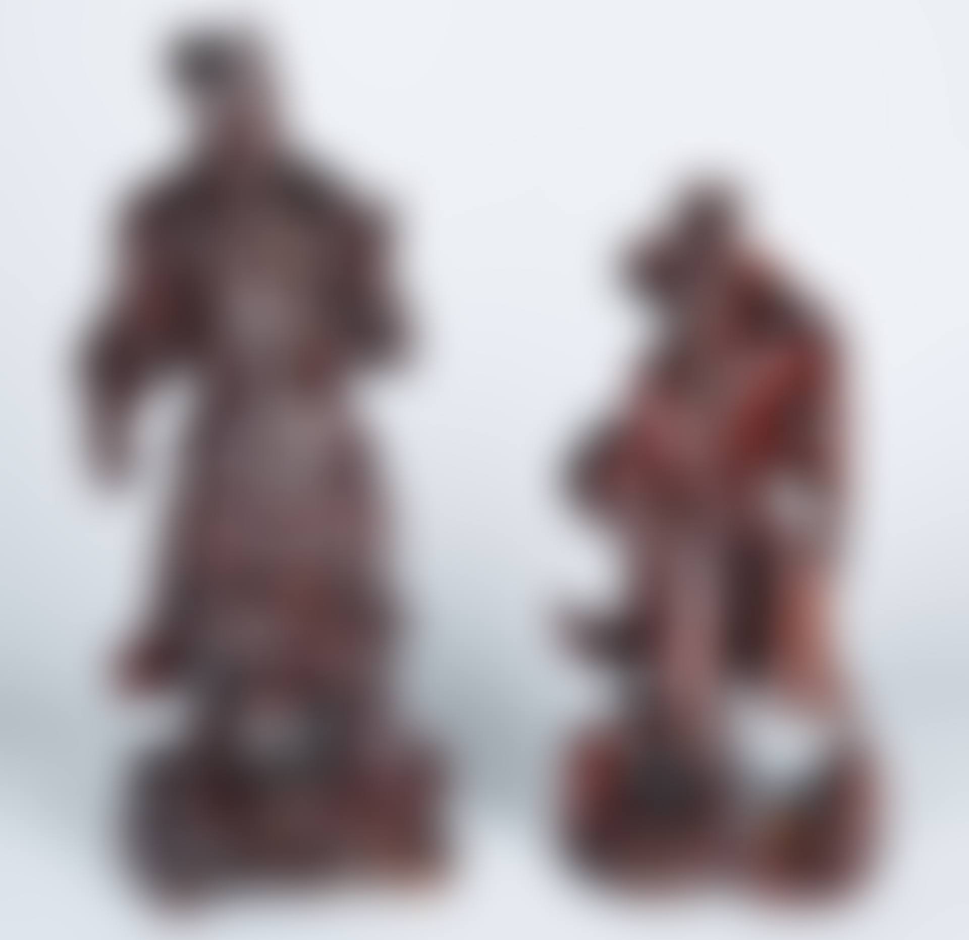 A PAIR OF FIGURAL CHINESE HARDWOOD CARVINGS OF A FISHERMAN AND A WARRIOR (preview)