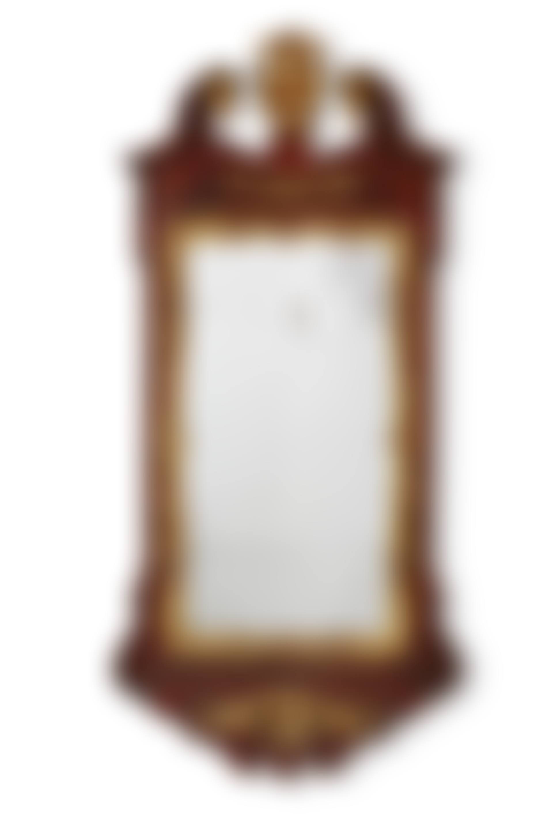 A GEORGE II CARVED MAHOGANY AND PARCEL GILT MIRROR (preview)