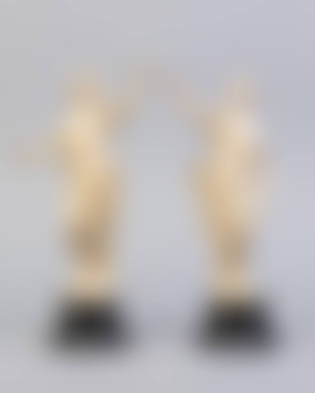 A pair of early 19th century French ivory figures of Greek huntresses on black socle bases (preview)