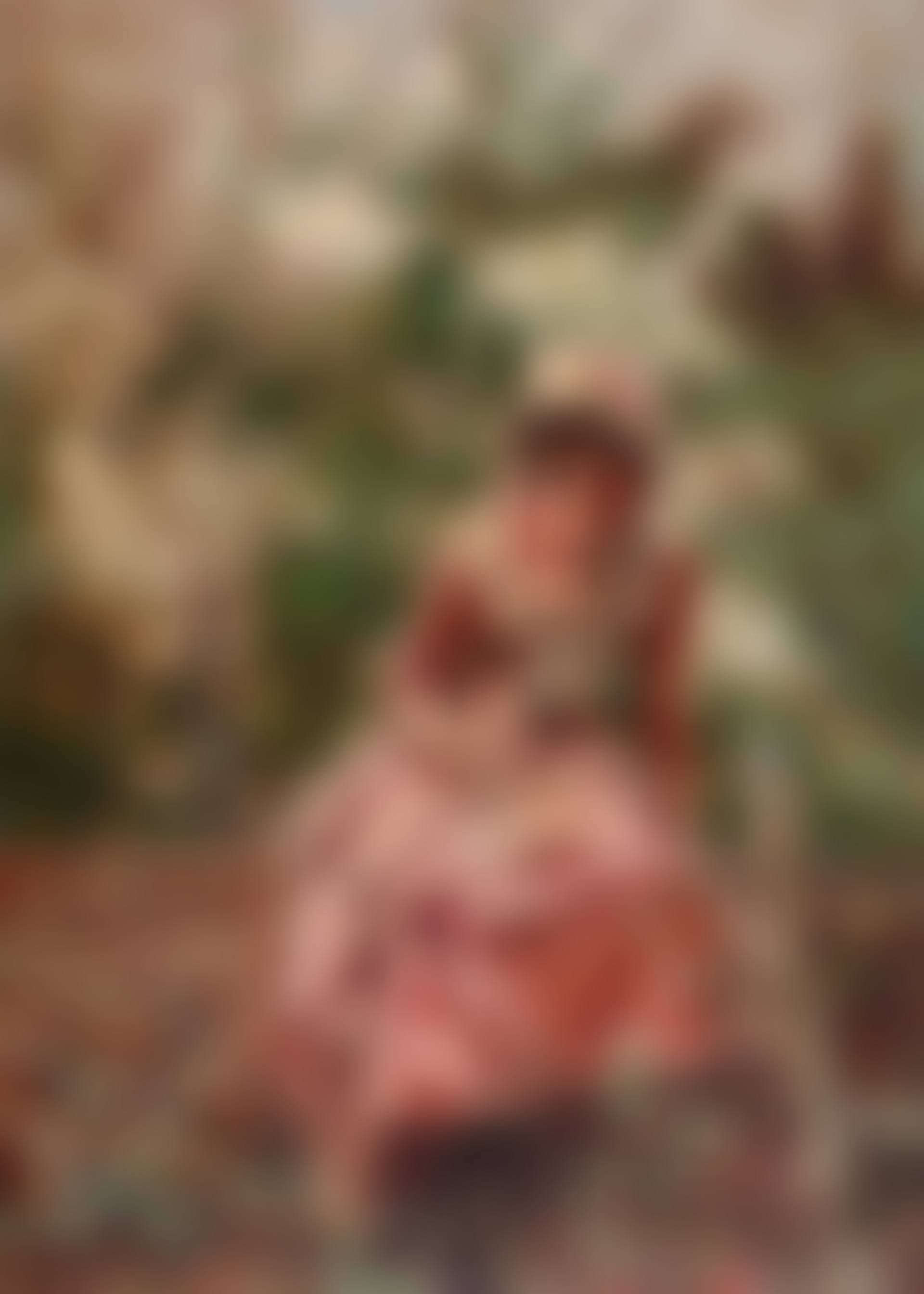 Portrait of a girl seated on a wall, wearing pink (preview)
