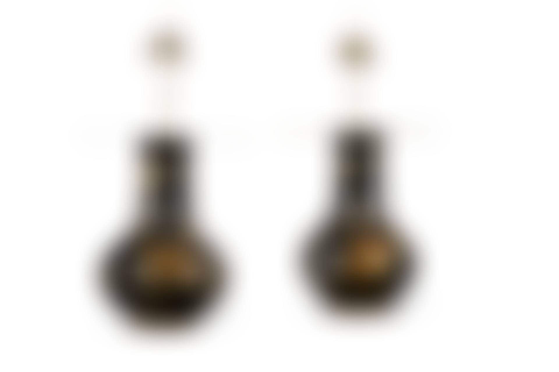 A PAIR OF MASSIVE MOLDED COMPOSITION EBONIZED AND PARCEL GILT BALUSTER VASES MOUNTED AS TABLE LAMPS (preview)