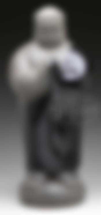 A standing figure in ceremonial pose with palms touched together and eyes closed (preview)
