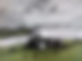 Anglesey landscape with the iconic coastal farm Penrhyn Du with Welsh blacks in the front field and the Rivals mountain-range beyond (preview)