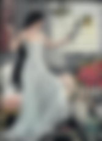 A young woman with long hair looking at herself in a mirror (preview)