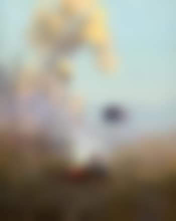 The Golden Northland, figure sitting at a campfire (preview)