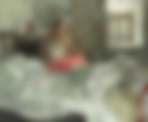 Lady seated on a bed (preview)