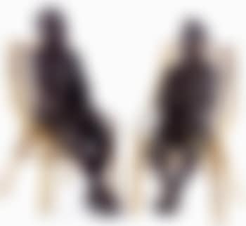 Two figures sitting on a bamboo chair (preview)