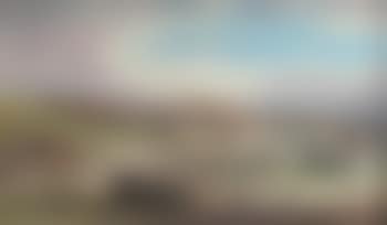 River estuary at low tide with windmills on a hill beyond (preview)