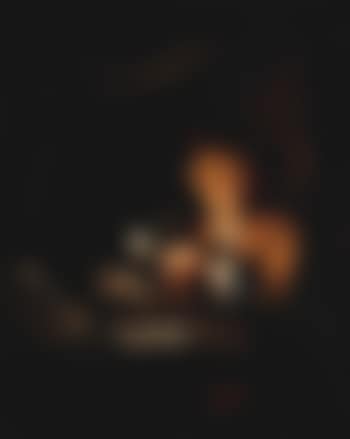 Candle-lit interior with young man seated at table holding roemer (preview)