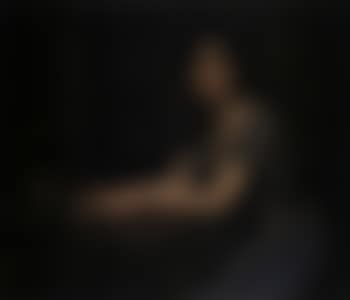 Portrait of a young woman at a table (preview)