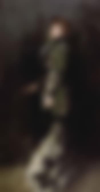 Portrait of young woman standing in long dress (preview)