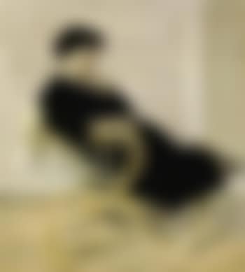 Young woman wearing a black dress sitting in a rattan chair (preview)