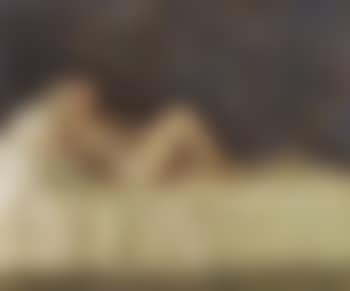 Scantily dressed woman reclining on sofa (preview)