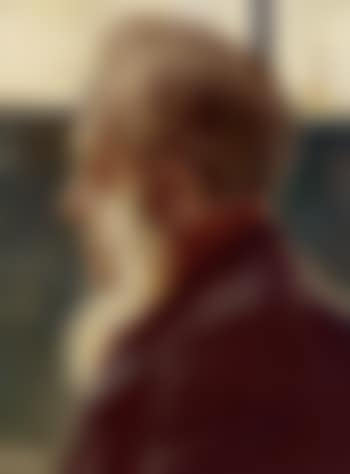 A man seen in profile with a window and a bottle in the background (preview)
