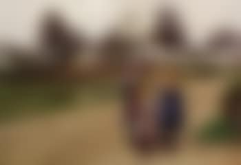 Four girls chatting in front of the village church (preview)