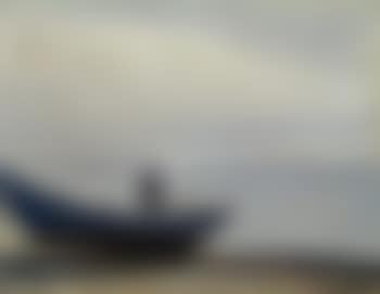 A fisherman and a dinghy on the beach in the blue evening light (preview)