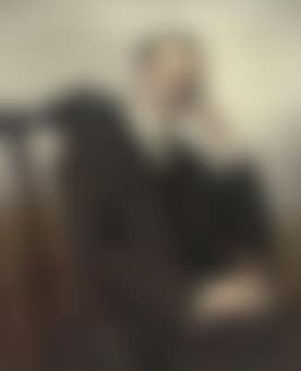 Portrait of Joseph Nissim Levy Esq, seated in a black suit and tie, a cigar in his right hand (preview)