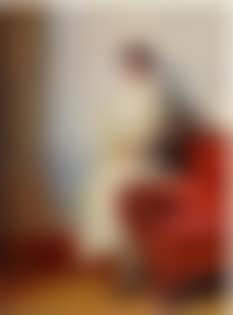 Portrait of Henny Brodersen seated on a sofa armrest (preview)