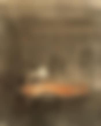 Evening interior with a figure at a table, presumably from the dining room of the Hammershøi family in a flat on Frederiksberg Allé in Copenhagen, the painter's childhood home (preview)