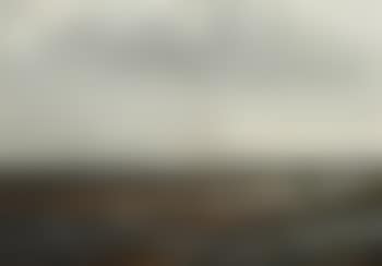 View Of A Rocky Shore With A Sailboat (preview)