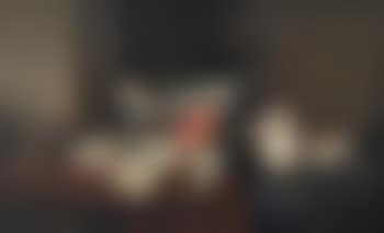 A lobster, cod, flatfish, salmon, crab, mussels and other fish in a wicker basket with a fish net on a partially draped table (preview)
