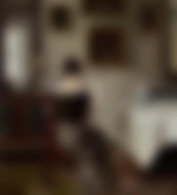 Interior with a woman reading the newspaper at the coffee table (preview)