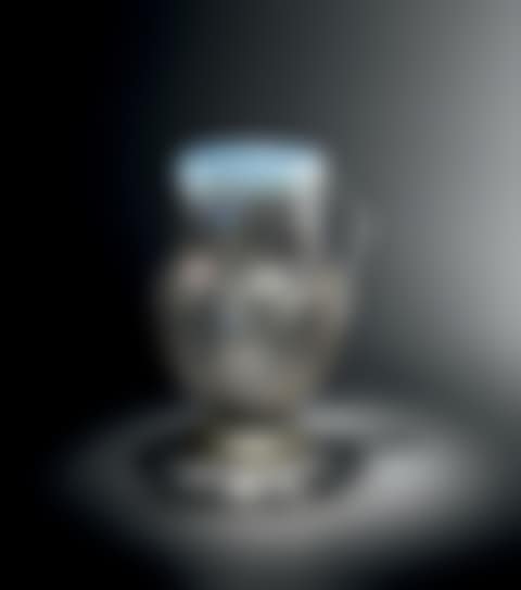 A grey opalescent glass pitcher with an ovoid body on a pedestal and a small grooved tubular neck with a hot-moulded spout and a small applied side handle (preview)