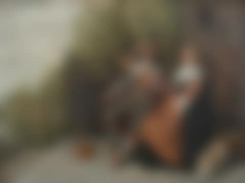 An elegant couple seated on a riverside terrace with a serving boy (preview)