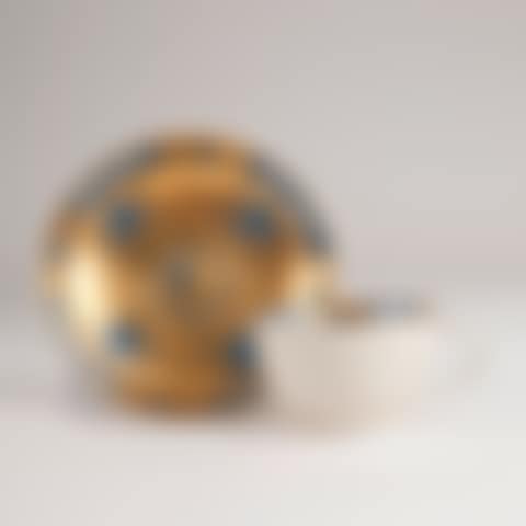 Miniature coppice with blue straw flowers in front of a gold background (preview)