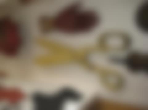Yellow-painted wooden clothing tailor"s sign depicting a pair of scissors (preview)