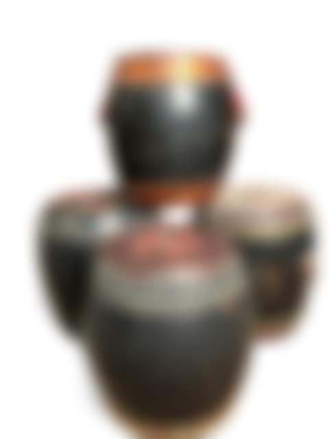 A group of four Chinese black lacquered and staved wood lidded rice barrels (preview)
