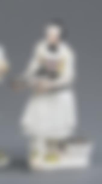 STATUETTE representing a woman holding a carp in her hands, standing on a terrace, a basket filled with fish at her feet, she is dressed in a white dress and wearing a black bonnet (preview)