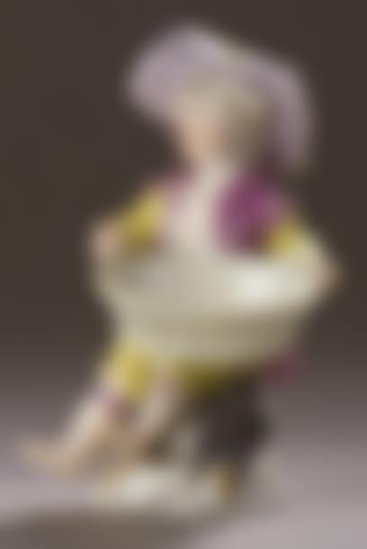 Porcelain statuette representing a young boy sitting, holding a basket on his knees (preview)