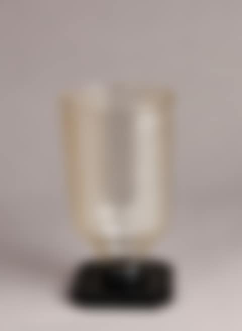 Truncated cone-shaped vase with alternating striations on a black square base (preview)
