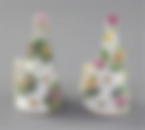 A pair of Meissen floral encrusted candle extinguishers (preview)